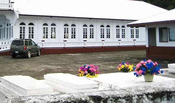 graves near a house and church
