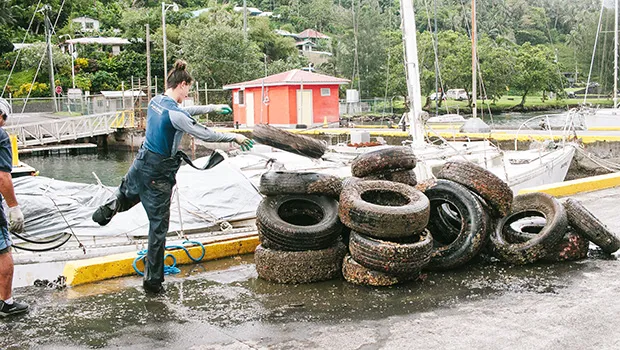 Stacking up tires cleaned up from the bottom of Malaloa Marina