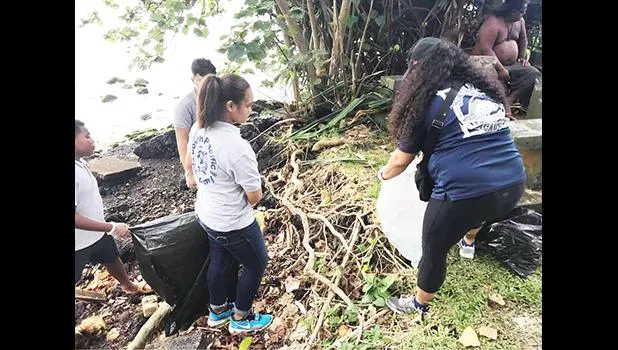 Students during a clean up project along the Pala Lagoon shoreline in Lions Park