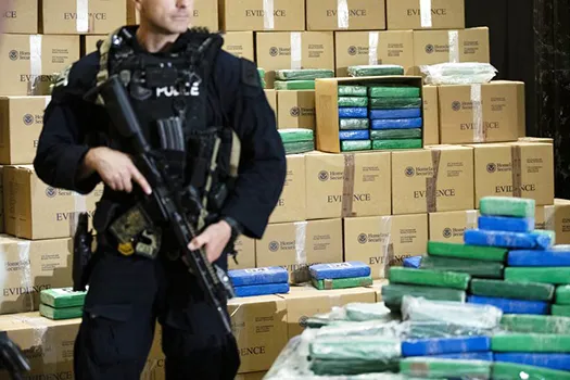 An officer stand guard over a fraction of the cocaine seized