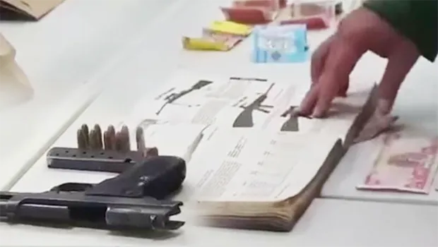 Iraqi money, illegal guns and ammunition, as well as a hardcover book with descriptions of various guns