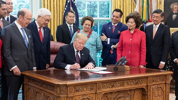 Aumua Amata and others watching Trump sign Executive Order