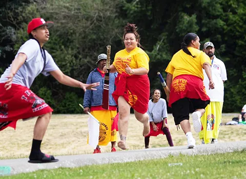 Teammates running after one of the women hit the ball 