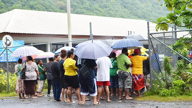 Crowd with umbrellas waiting at DMWR gate