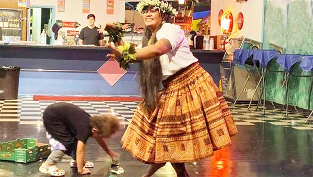 Lehualani Fa’aati Uluenga Gillis dancing as child picks up money being thrown