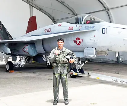 Daniel McMoore with a U.S. Navy fighter jet