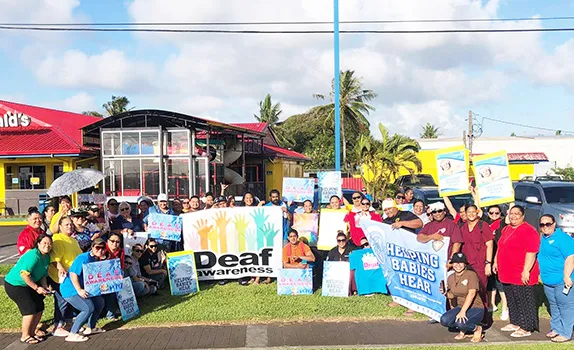 Deaf Awareness Month wave in front of McDonald's