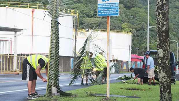 Customs personnel decorating for Flag Day across from the tank farm.