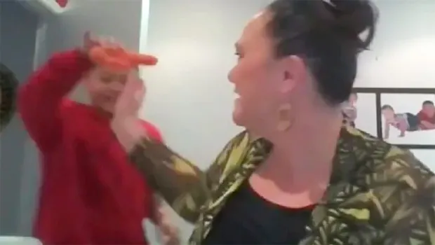 Son with carrot and mom trying to grab it