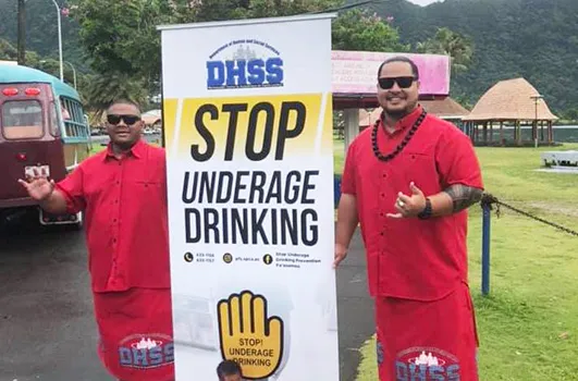DHSS staff with prevent underage drinking sign