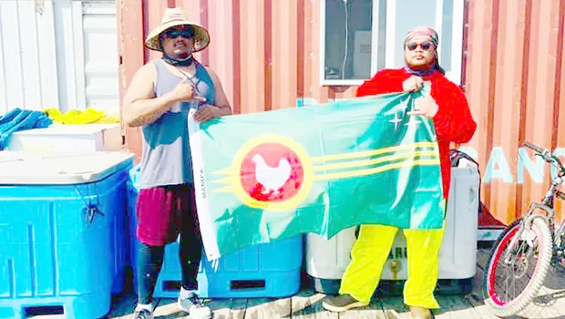 Two men in Alaska holding the Manu'a flag
