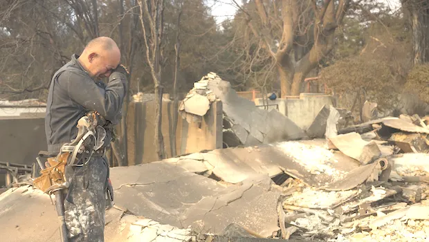 Cesar Plaza becomes emotional while looking at his home destroyed