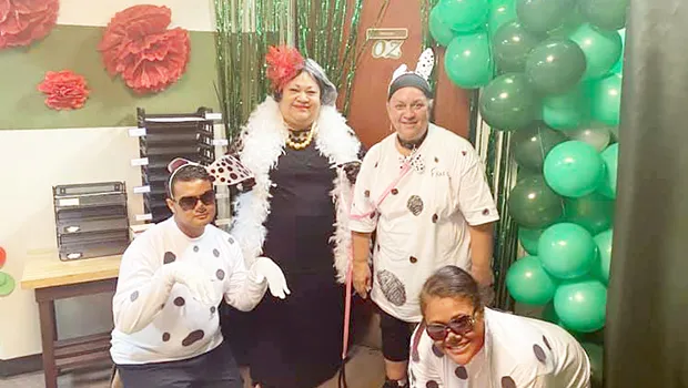 Cruella is having a grand time with her Dalmatians