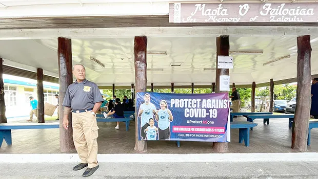 Man standing in front ofSamoa Baptist Academy’s Samoan fale 