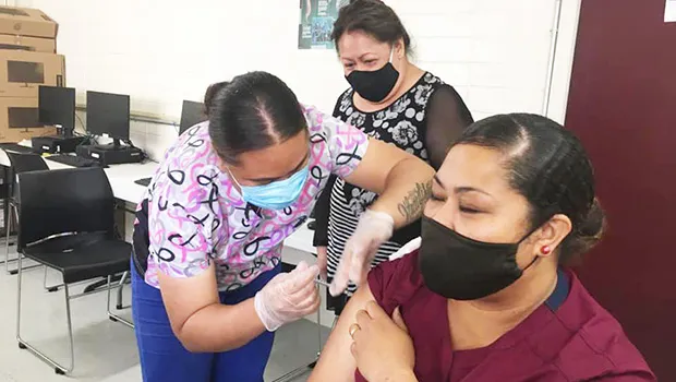 Med staff administering a covid-19 vaccination