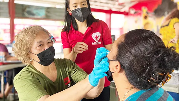 A teacher learning how to administer rapid COVID test
