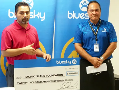 Ethan Lake (left) accepting a $20,600 contribution from Bluesky Pacific Group chief executive officer Toleafoa Tiafau Douglas Creevey 