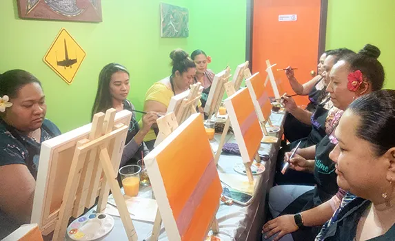 A group of friends each painting a picture