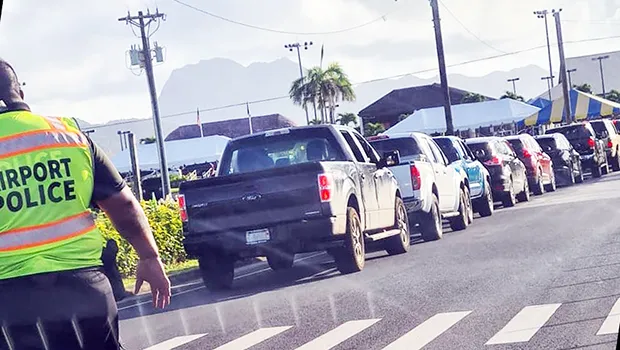 An  Airport Police officer monitoring traffic at drive-thru vax clinic