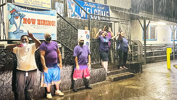 StarKist employees waving for Domestic Violence Awareness Month in the rain