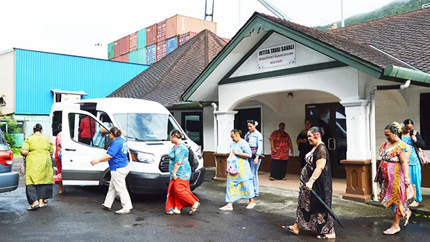 ECE teachers walking toward a van to go to the residence of the ECE Director in Vaitogi