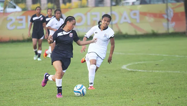 Eliza Berondo of Amercan Samoa dribbles the ball