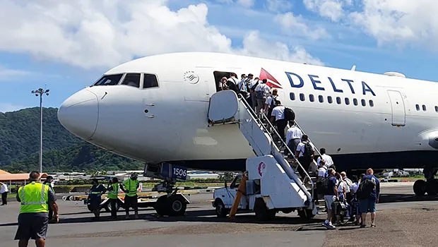 The last of the 29 missionaries of the Church of Jesus Christ of Latter Day Saints boarding the Delta Air Lines charter flight