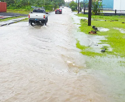 Car attempting to drive through flood waters in Fagaima