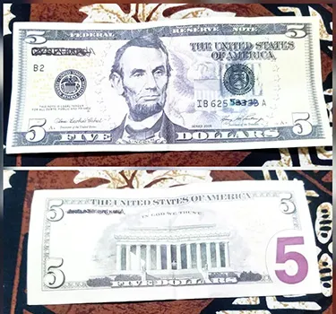 Photos of back and front of fake $5 bill.