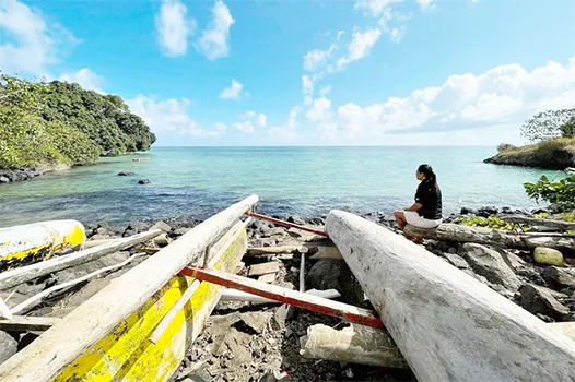 Eseta Vusamu sits near the water