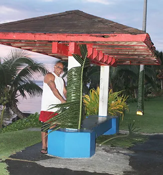 amoa Environmental Protection Agency employee decorating for a scaled-down Flag Day celebration