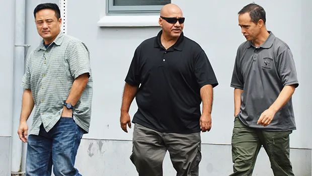 Three federal agents outside of the District Court