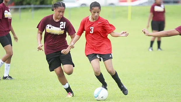 A Faga’itua player (right), dribbles against a Tafuna opponent 