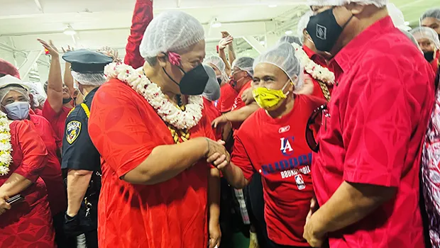 Samoa Prime Minister Fiame Naomi Mataafa shakes hands with a StarKist employee