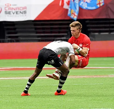 Canada’s Luke McCloskey is pummeled by Fiji’s Aminiasi Tuimaba