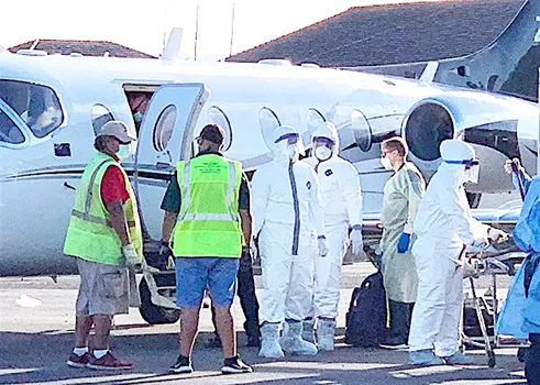 Ground crew and medical personnel on the tarmac at the Pago Pago International Airport 