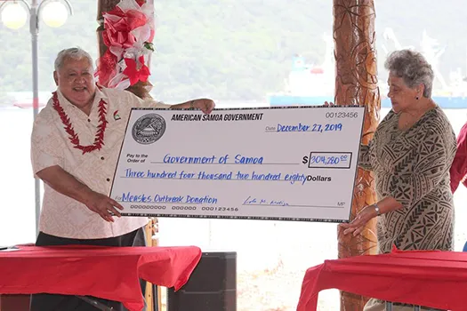 First Lady Cynthia Malala Moliga (right) presents check to PM Tuilaepa 