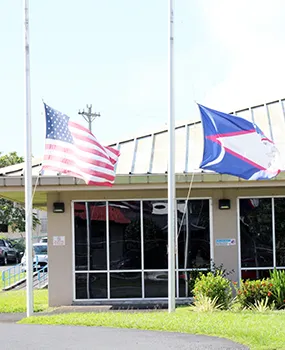 American Samoa and U.S. flags at half staff
