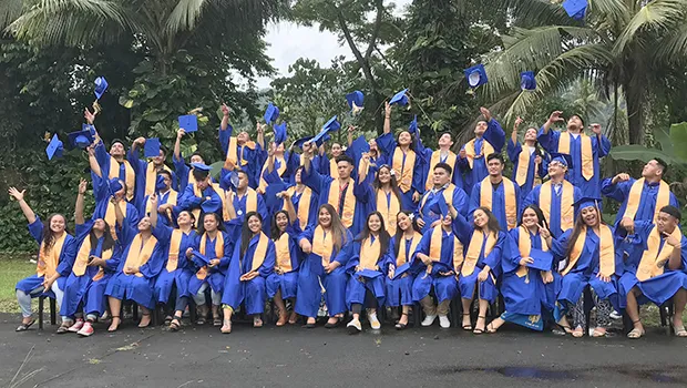 Fa’asao Marist High School 2020 graduates throwing caps in the air