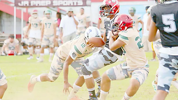 Scott Pese is brought down by two Team Fealofani defenders