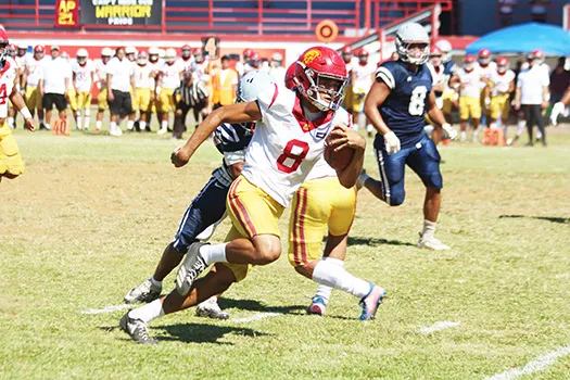 Tafuna Warriors quarterback Oakland Salave’a scrambling through midfield 