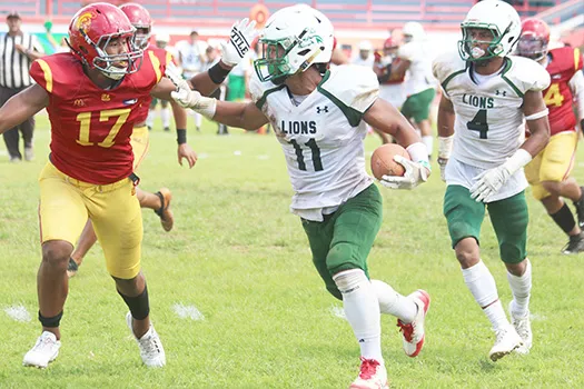 Pearson Livi of the Leone Lions focus on timing his stiff arm 