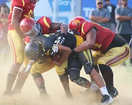 Nu’uuli Wildcats quarterback Nathaniel Maea is swallowed in the backfield for a loss by