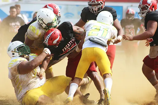 Leone Lions’ beastly defensive lineman Cyan Fiatoa and his teammates bringing down Joseph Umu