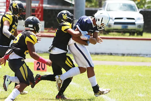 Avory Seumanutafa of the Blue Empire dragging a defender with him 