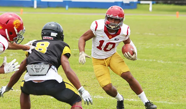 Tafuna Warriors’ John Allen (10) tries to evade a Nu’uuli Wildcat