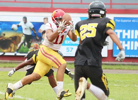 Herman Sufia (11) of the Tafuna Warriors focusing on catching this perfectly placed pass by Salave’a