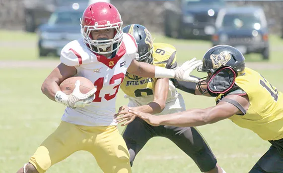 Tafuna’s ball carrier trying to evade the pressure from two Nu’uuli Wildcat defenders