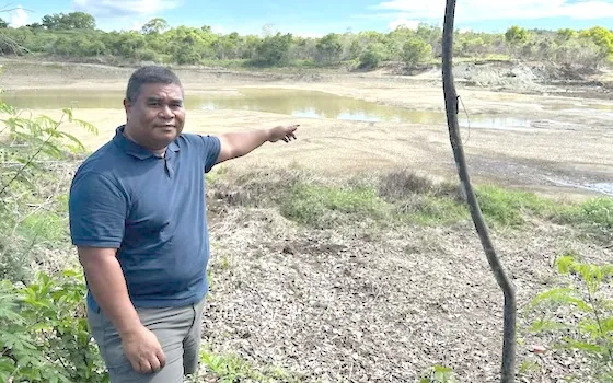 Mayor Jeff Adalbai looks at the water level 