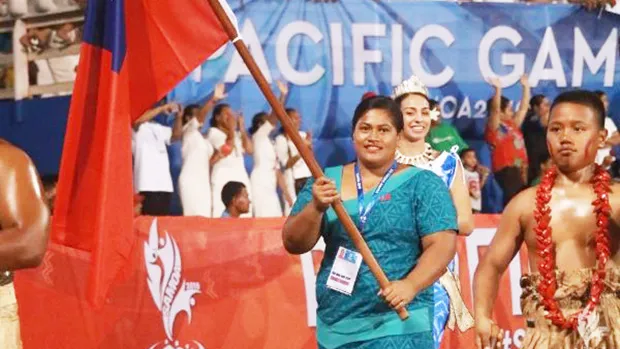 Samoan weightlifter Feagaiga Stowers carrying Samoa flag